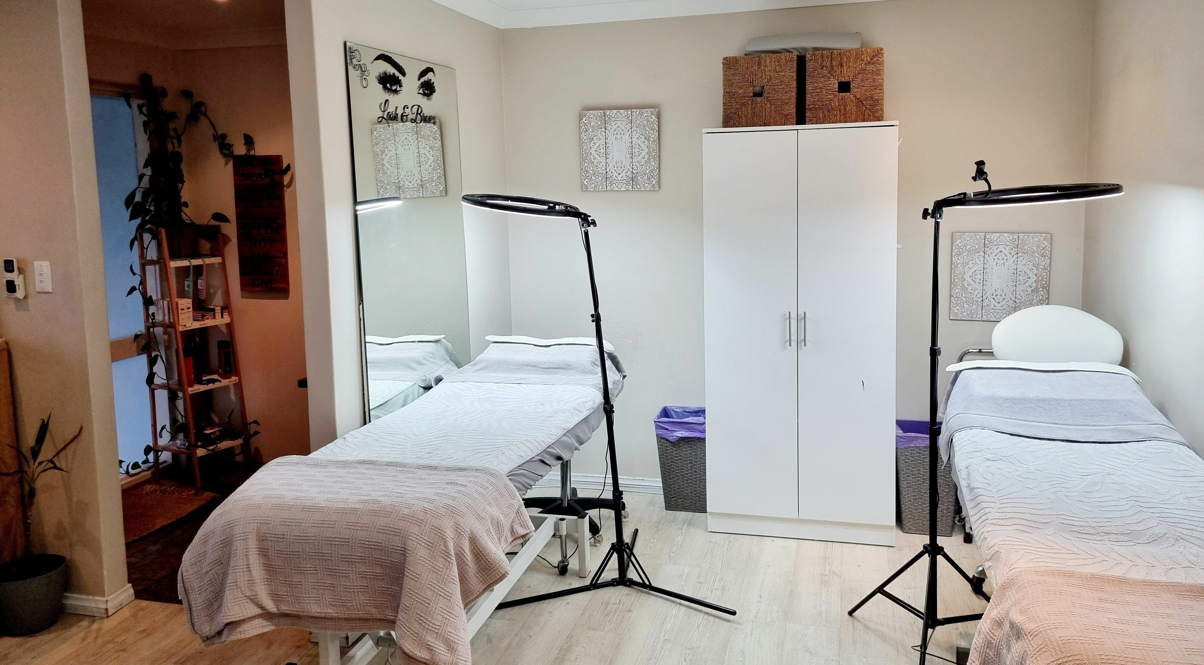Cozy treatment room at Belle Grace Hair and Beauty, Mullaloo, WA, AU with two spa beds and warm lighting.