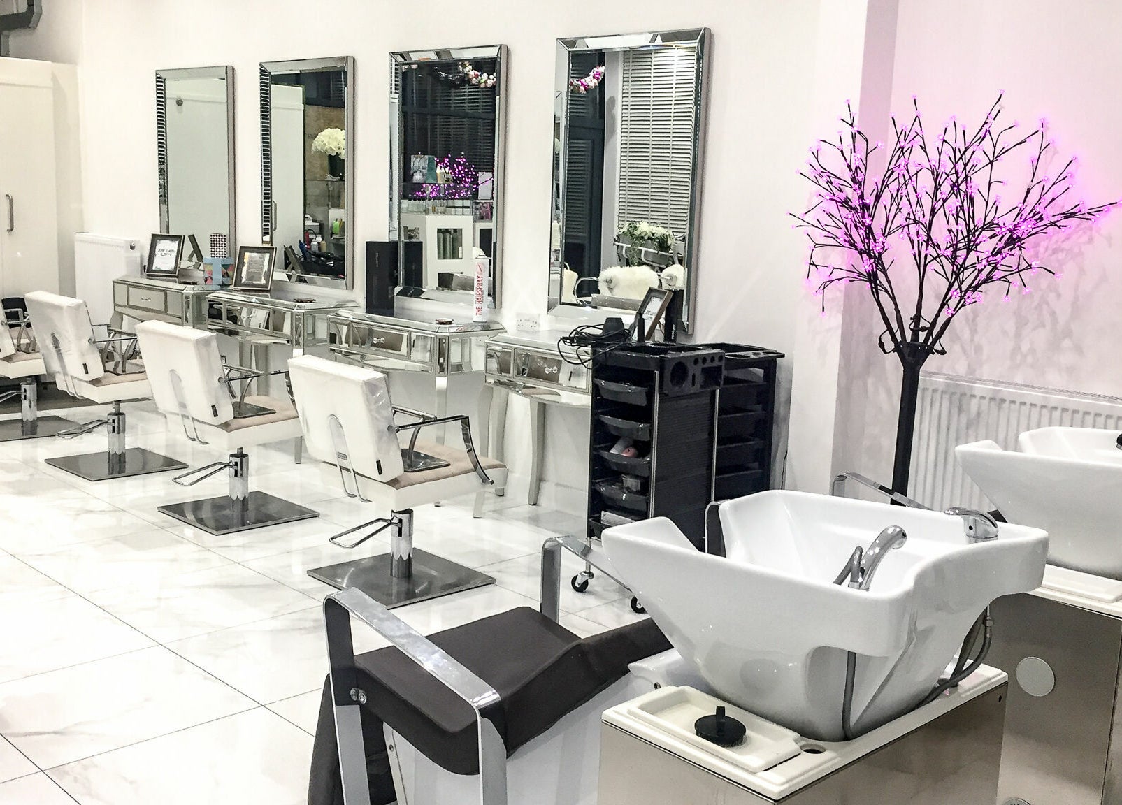 Modern salon chairs and mirrors at Glam and Go, Bamber Bridge, England, GB, enhance this chic beauty space.