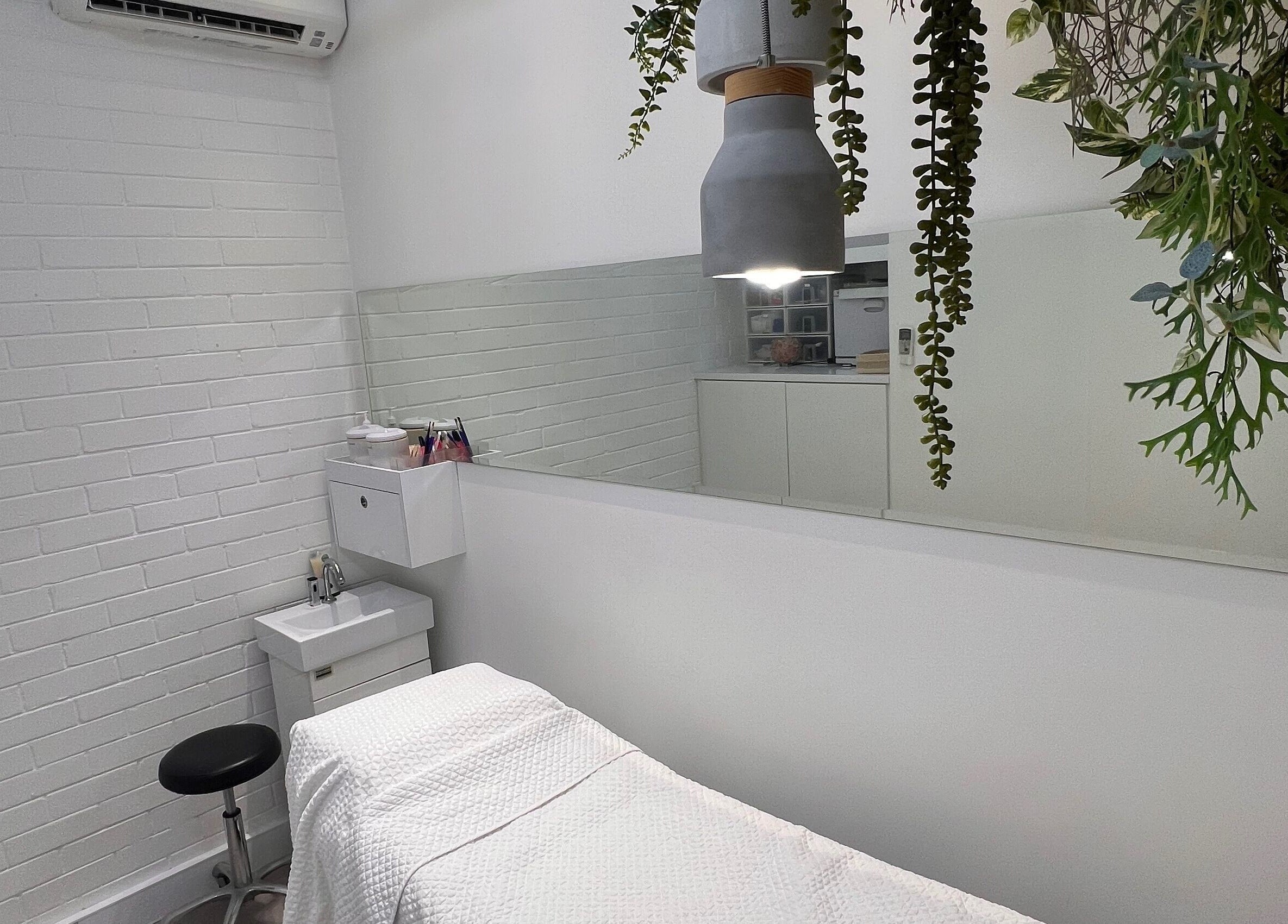 Serene treatment room at The Skin Genesis Collective, Nedlands, Western Australia, AU, with modern decor.