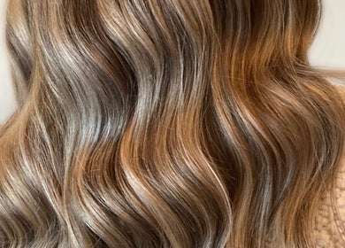 Long, wavy blonde hair styled at Gemma B Holistic Hairdressing in Dunstable, England, GB.