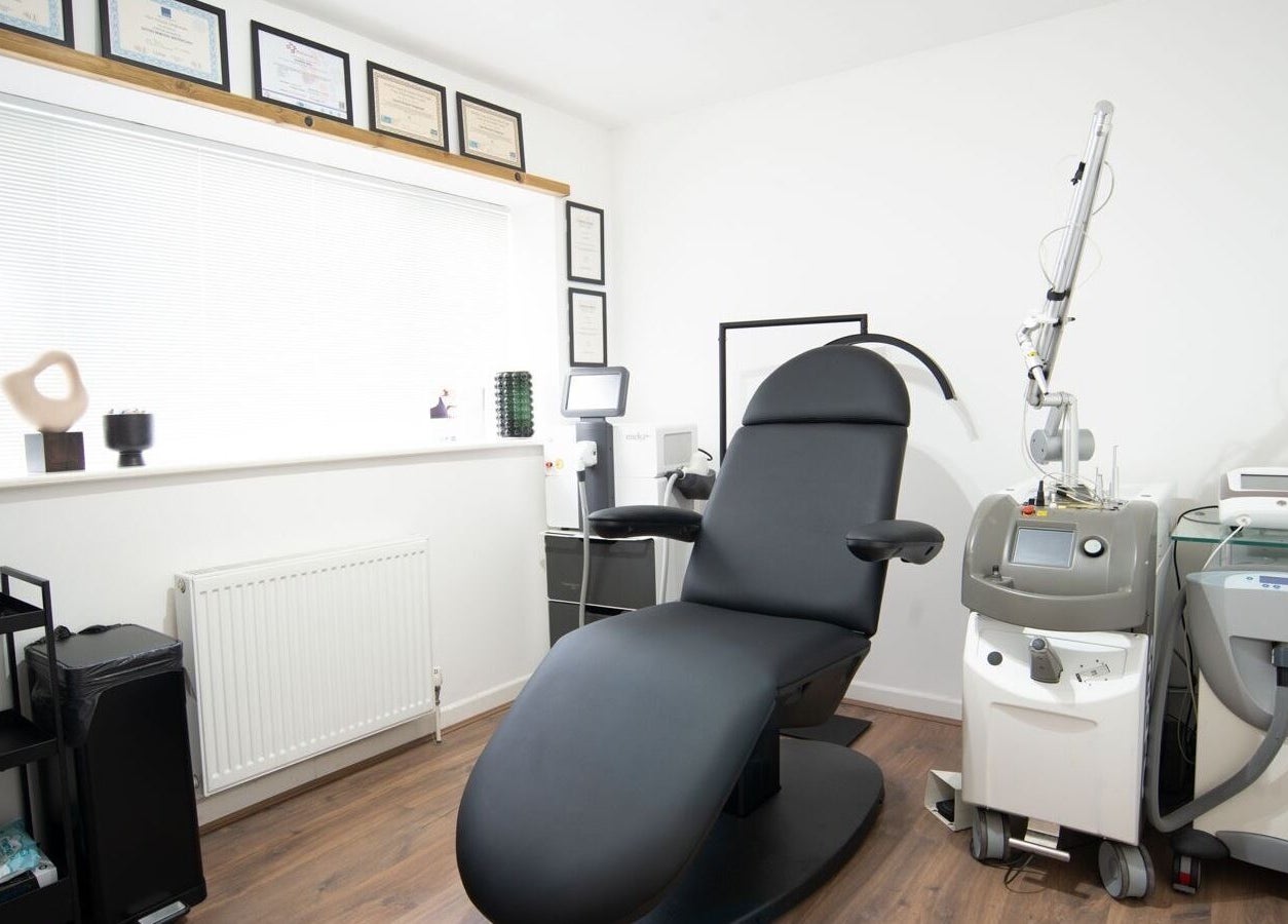 Tattoo removal room at Erase That Ink, Newton Abbot, England, showcasing modern equipment and treatment chair.