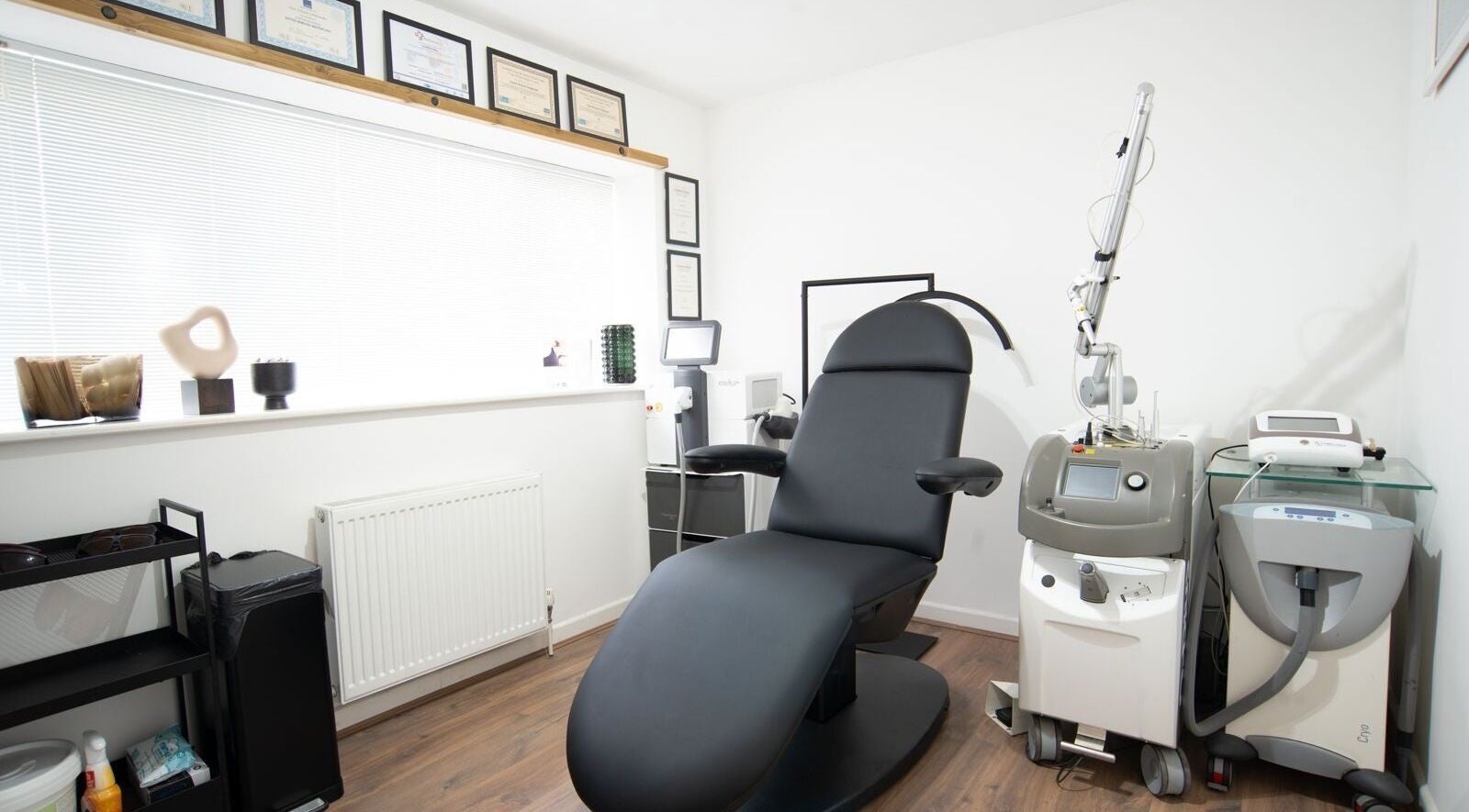 Tattoo removal room at Erase That Ink, Newton Abbot, England, showcasing modern equipment and treatment chair.