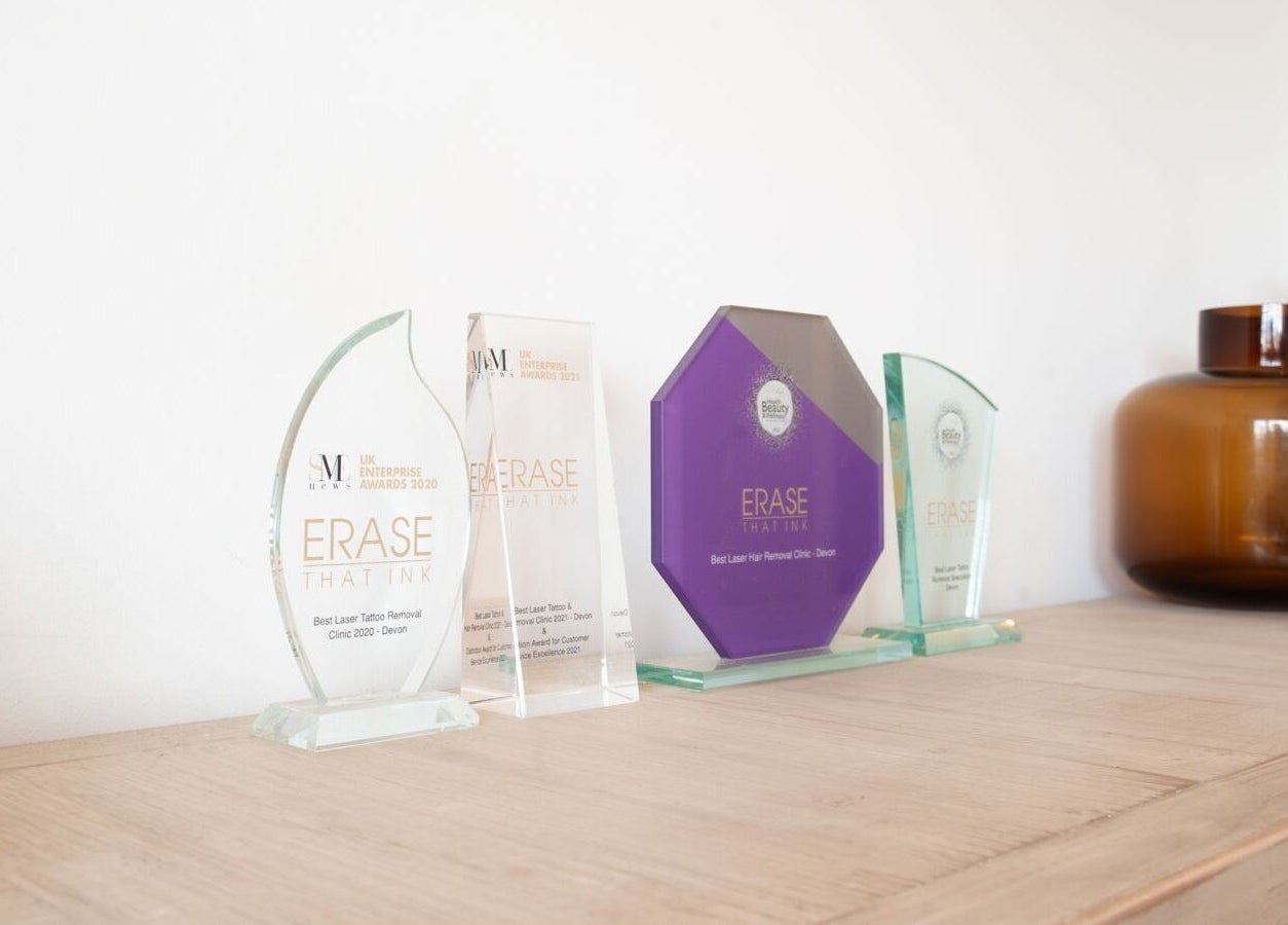Awards displayed at Erase That Ink, Newton Abbot, England, GB, highlighting excellence in tattoo removal.