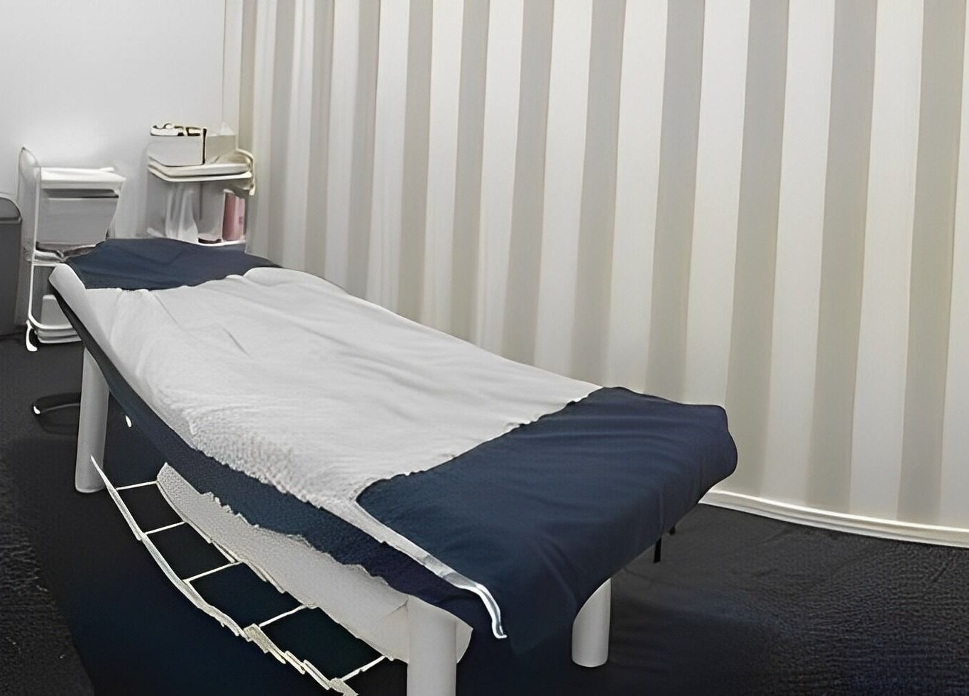 Relaxing spa room at Pari's Hair and Beauty Salon, Hamilton, Waikato, NZ, featuring a massage table and serene decor.