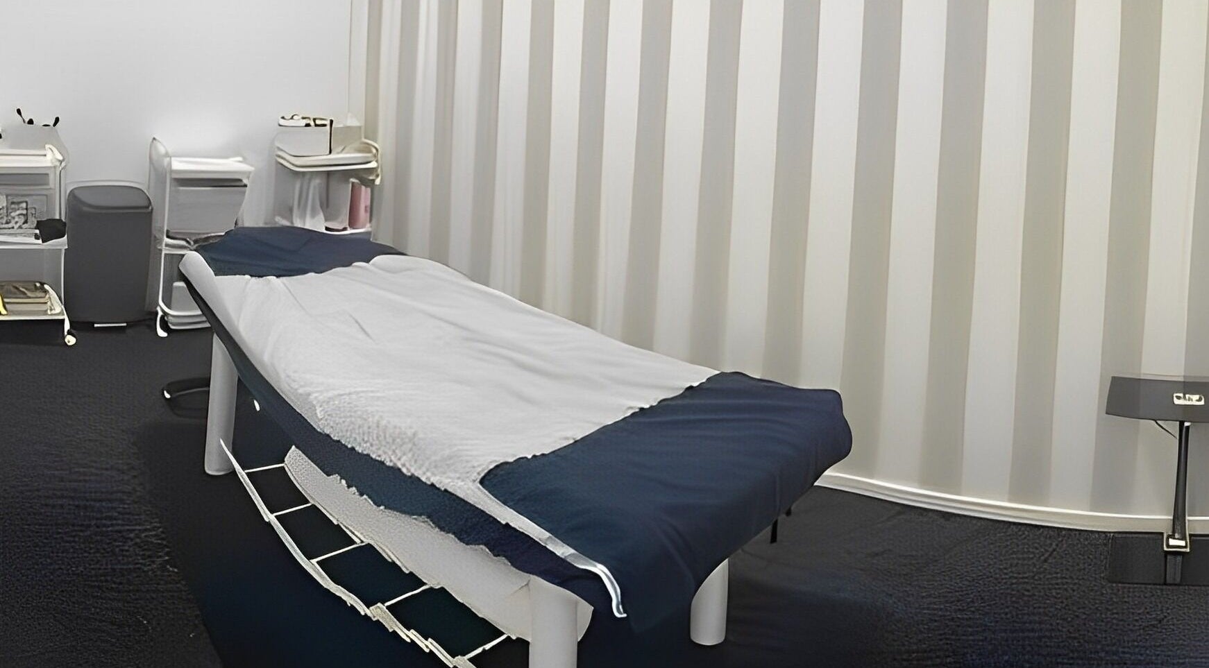 Relaxing spa room at Pari's Hair and Beauty Salon, Hamilton, Waikato, NZ, featuring a massage table and serene decor.