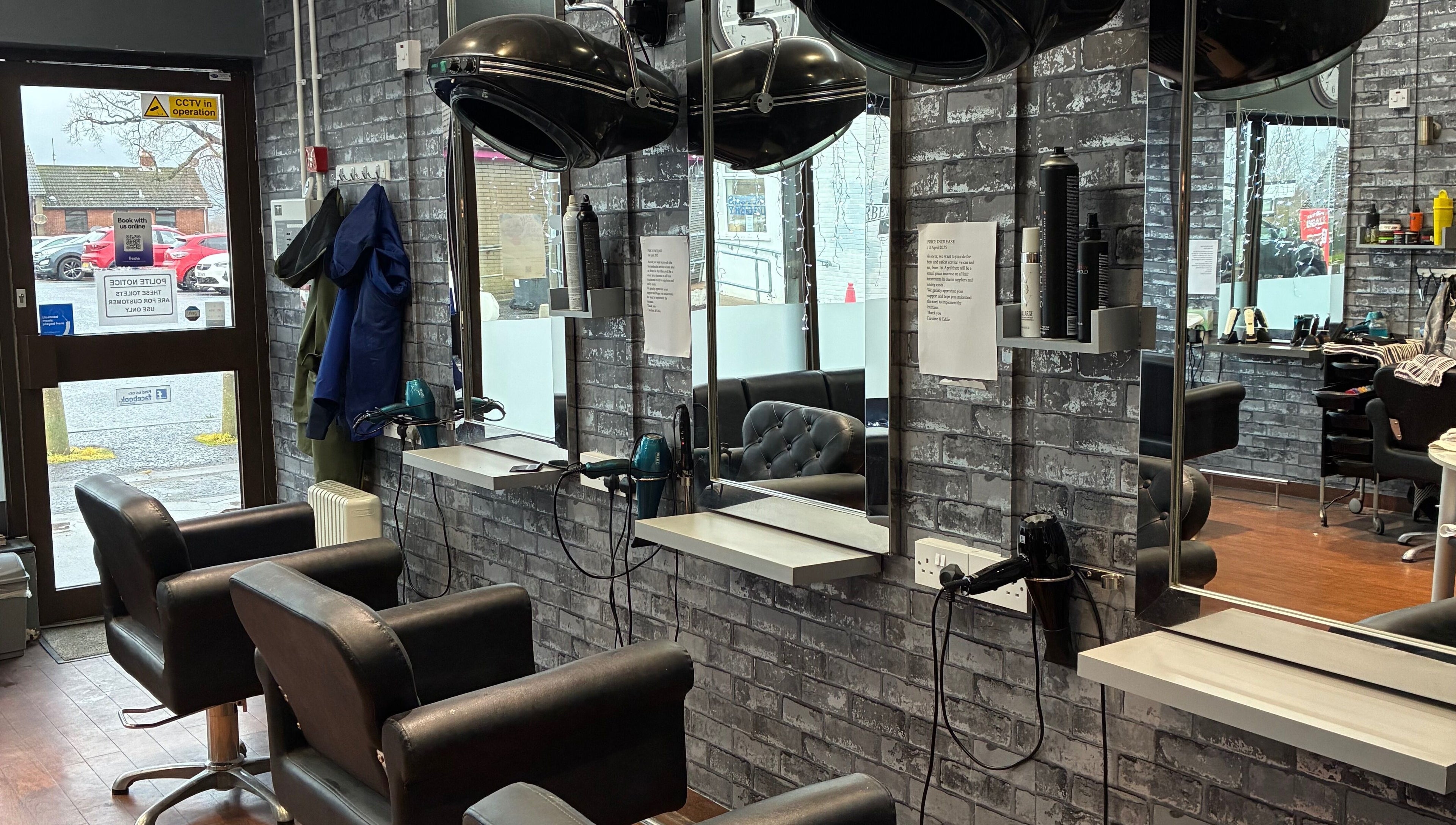 Modern salon at Edwins Hair and Skincare Centre in Belfast, Northern Ireland, GB, featuring stylish mirrors and chairs.