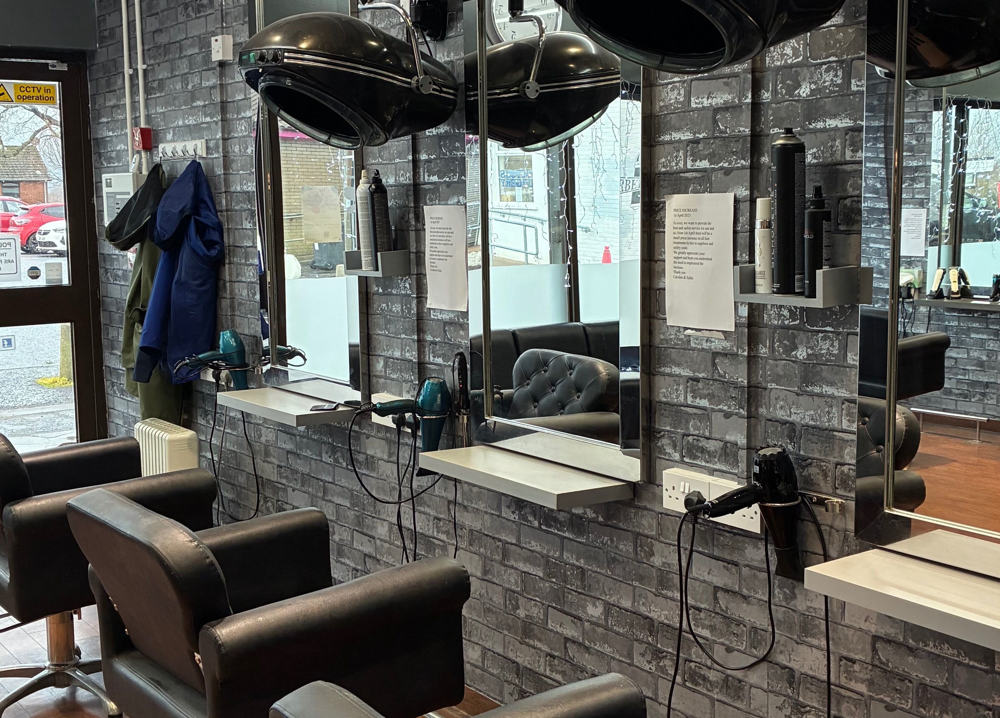 Modern salon at Edwins Hair and Skincare Centre in Belfast, Northern Ireland, GB, featuring stylish mirrors and chairs.