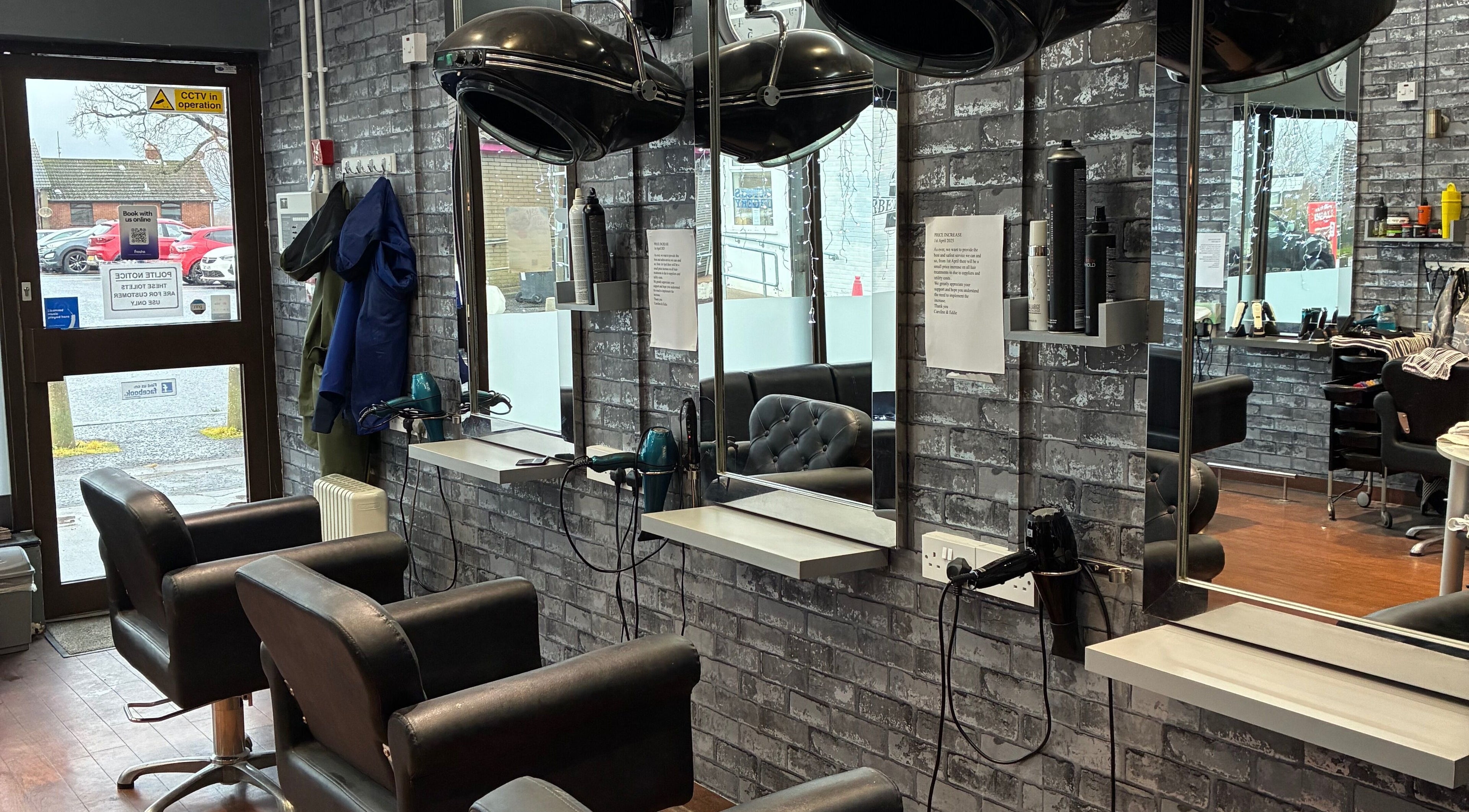 Modern salon at Edwins Hair and Skincare Centre in Belfast, Northern Ireland, GB, featuring stylish mirrors and chairs.