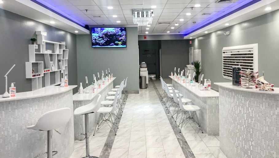 Modern interior of Epic Nail Bar, Orleans, Massachusetts, US with sleek nail stations and white decor.