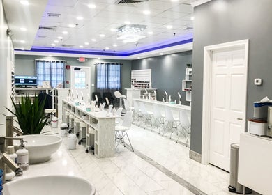 Spacious interior of Epic Nail Bar in Orleans, Massachusetts, US, featuring modern decor and nail stations.