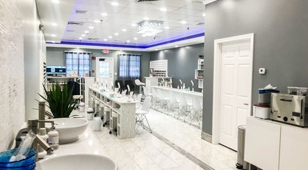 Spacious interior of Epic Nail Bar in Orleans, Massachusetts, US, featuring modern decor and nail stations.