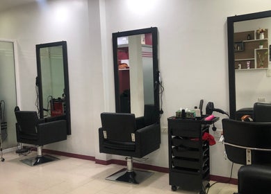 Elegant salon setup at Gloss Salon in Malé, Male, MV, featuring modern chairs and styling stations.