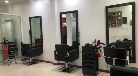 Elegant salon setup at Gloss Salon in Malé, Male, MV, featuring modern chairs and styling stations.