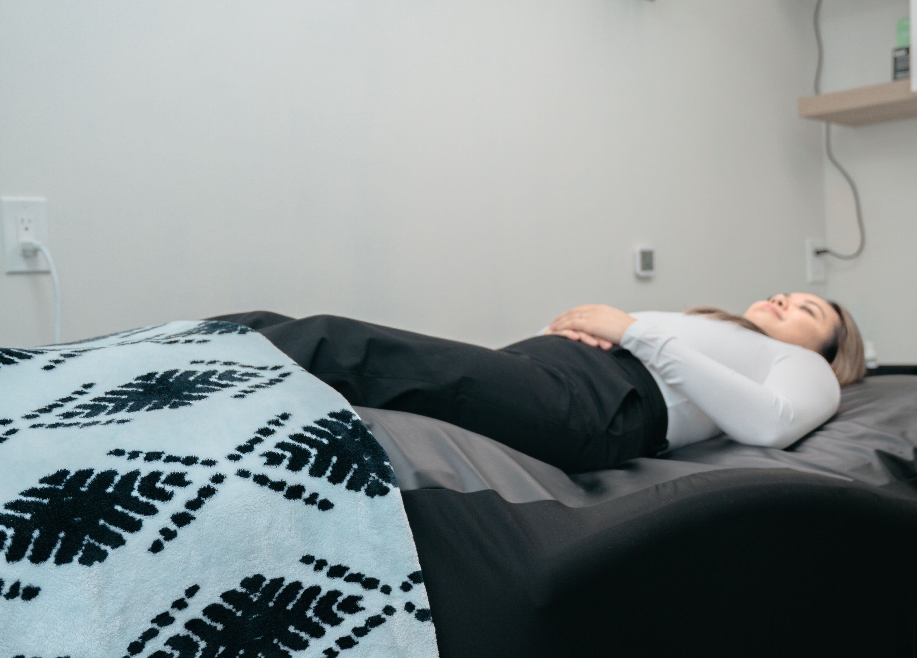 Client relaxing during treatment at KALOLOGY, Winnipeg, Manitoba, CA.