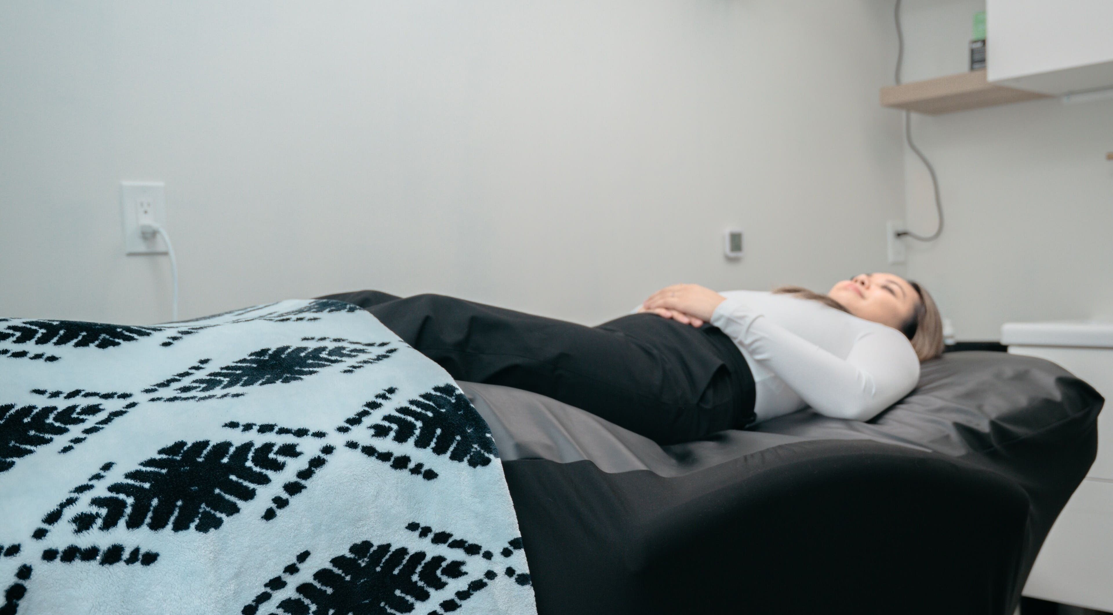 Client relaxing during treatment at KALOLOGY, Winnipeg, Manitoba, CA.