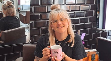 Smiling stylist enjoying coffee at Alice Woolf salon, Gloucester, England, GB.