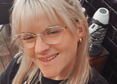 Smiling person at Alice Woolf salon, Gloucester, England, GB, showcasing modern beauty styling.