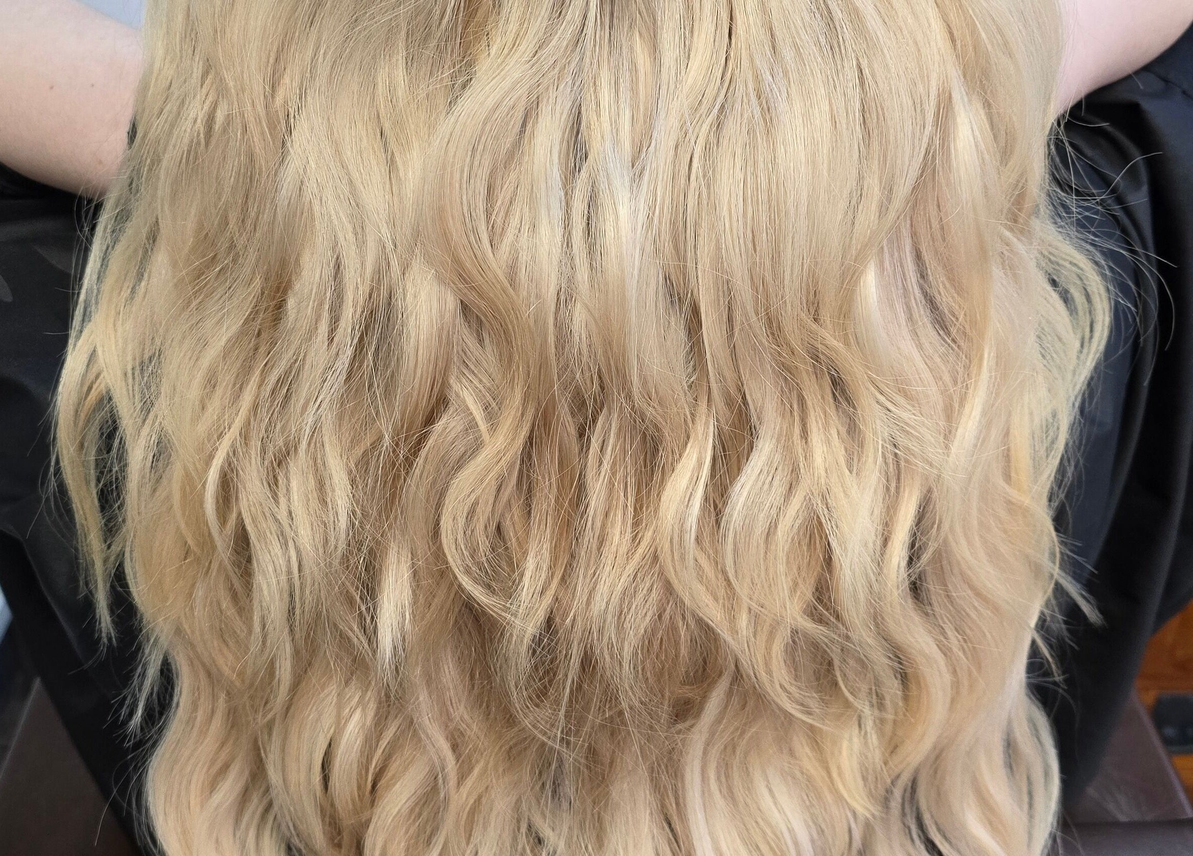 Blonde wavy hair styled at Alice Woolf, Gloucester, England, GB salon chair.