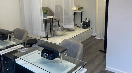 Chic interior view of The Beauty Chambers in Birmingham, England, GB showcasing elegant spa chairs and tables.
