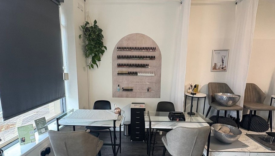 Chic nail salon interior at The Beauty Chambers, Birmingham, England, GB with modern decor and cozy seating.