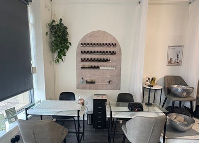 Chic nail salon interior at The Beauty Chambers, Birmingham, England, GB with modern decor and cozy seating.