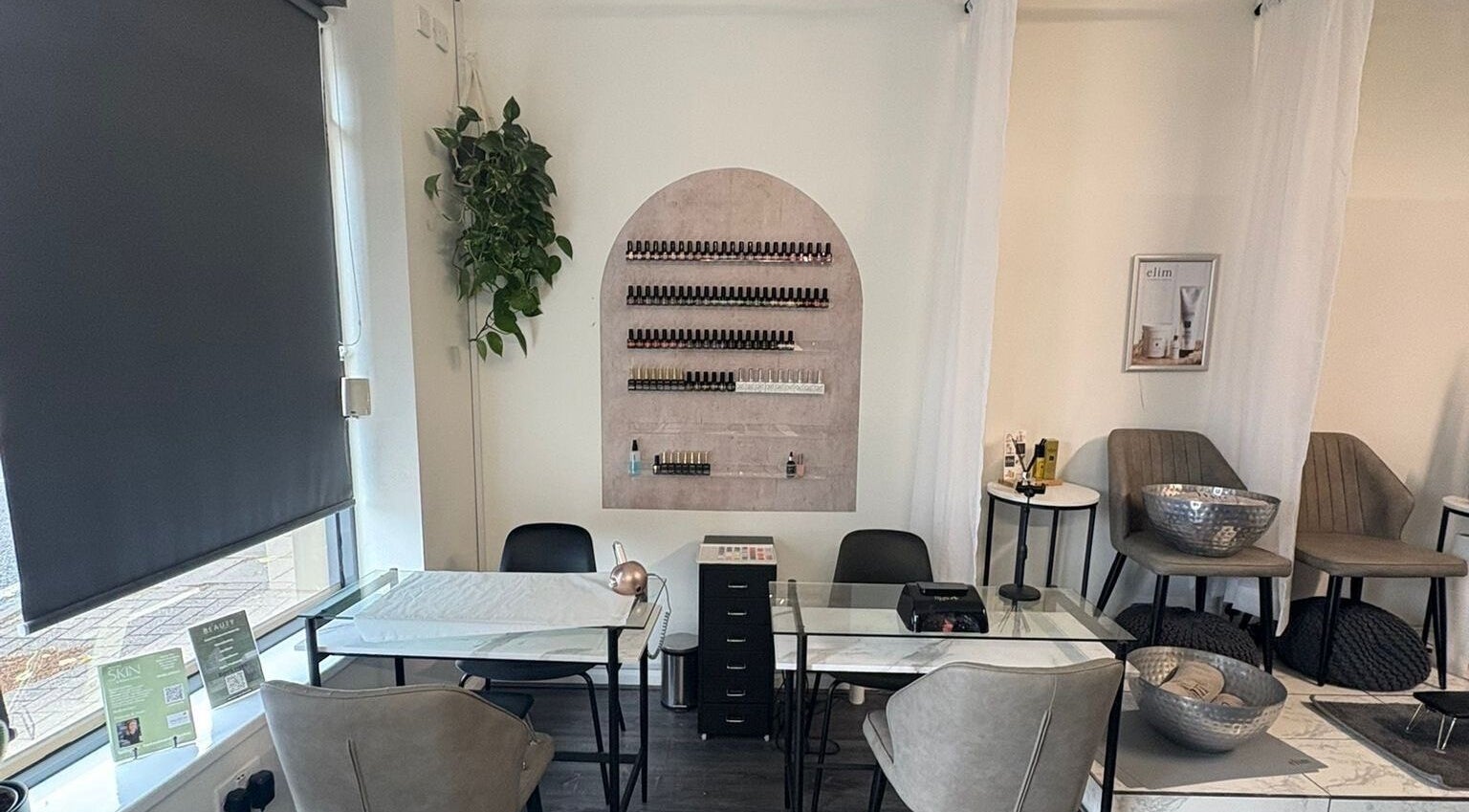 Chic nail salon interior at The Beauty Chambers, Birmingham, England, GB with modern decor and cozy seating.