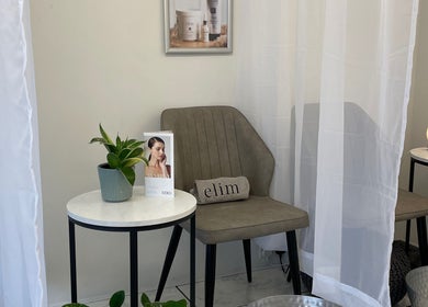 Calm beauty nook at The Beauty Chambers, Birmingham, England, GB with a cozy chair, table, and plant.