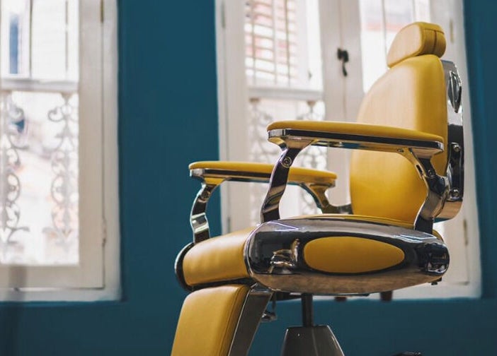 Chic yellow salon chair at Bodeiga, Singapore, SG offering stylish wellness ambiance.
