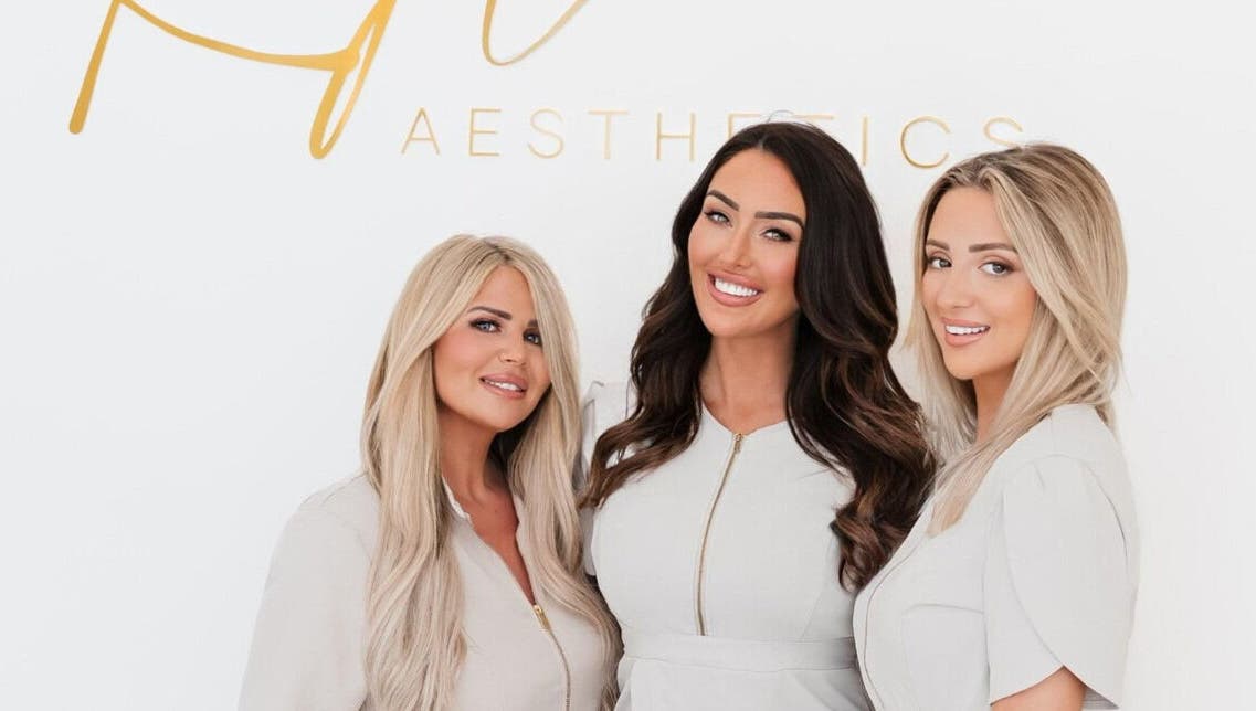 Team smiling at Kylie Aesthetics, Christchurch, GB offering premium beauty services.