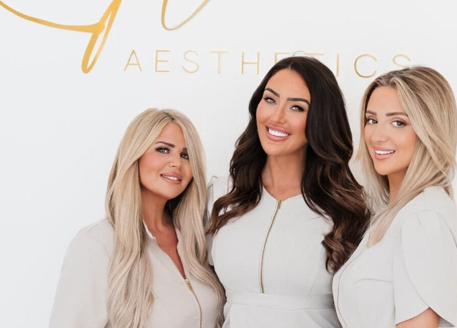 Team smiling at Kylie Aesthetics, Christchurch, GB offering premium beauty services.