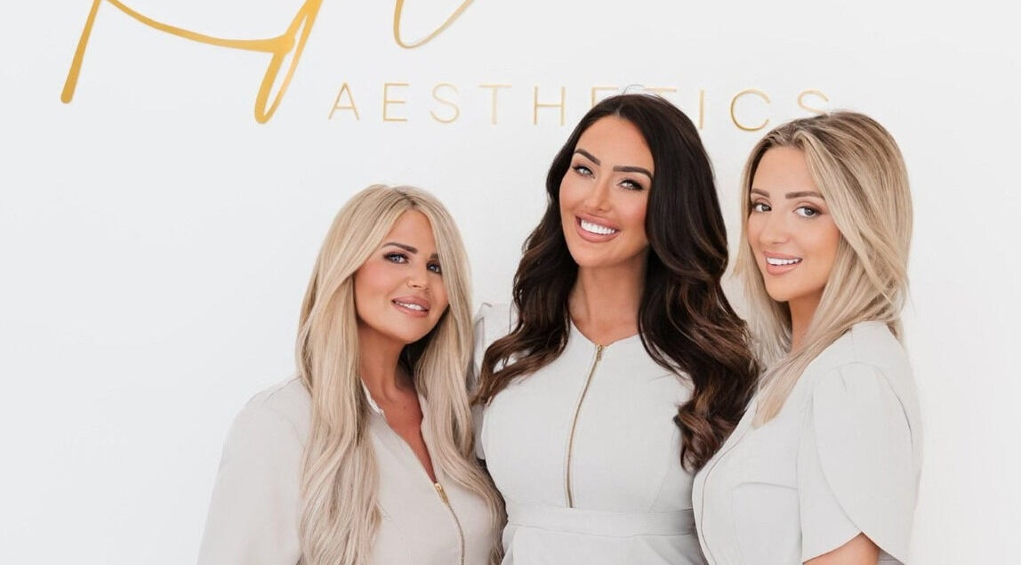 Team smiling at Kylie Aesthetics, Christchurch, GB offering premium beauty services.