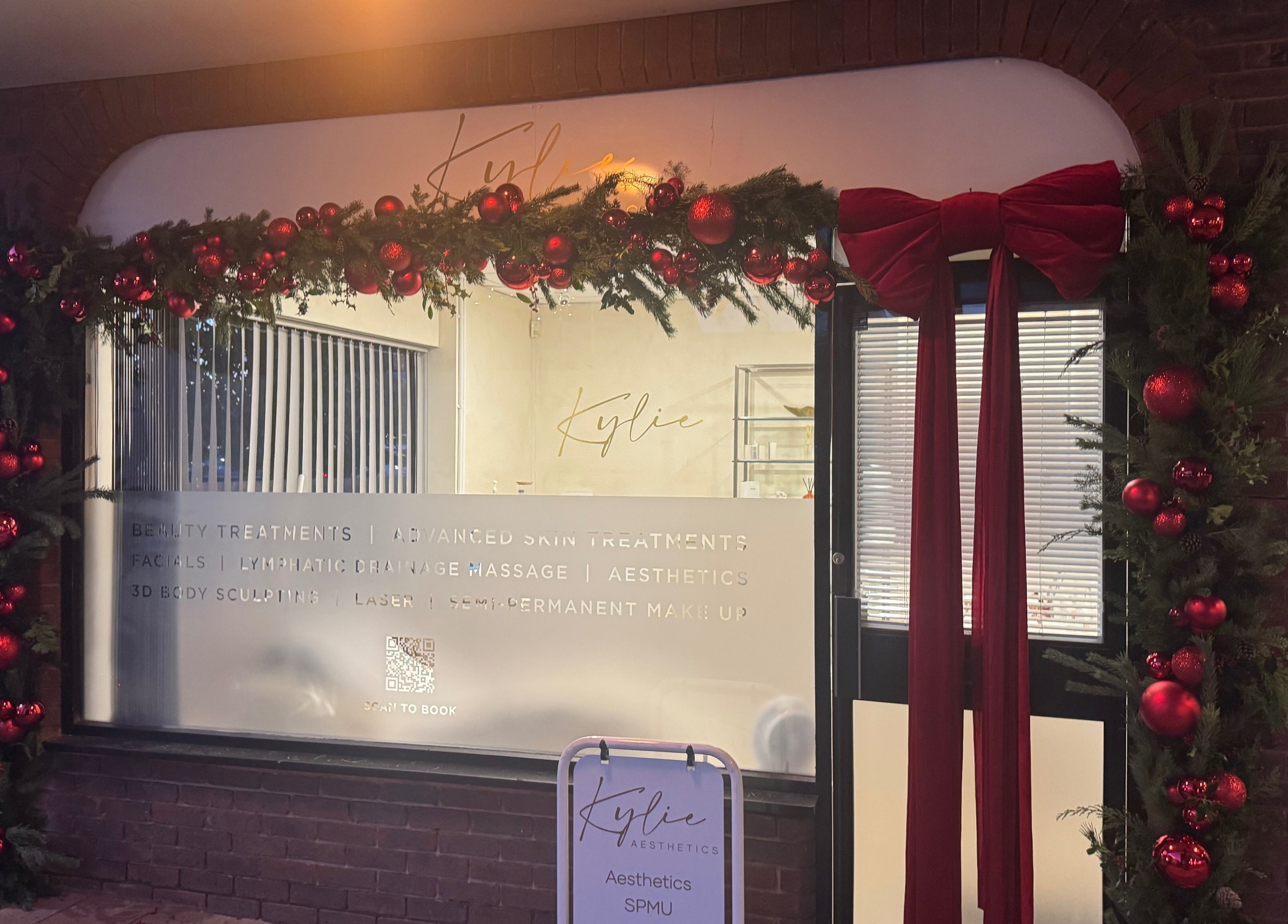 Kylie Aesthetics at Christchurch, GB decorated elegantly with a festive red garland and branded window signage.
