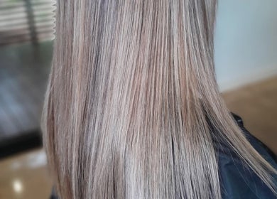 Sleek, silky blonde hair styled at Lelani Hair in Broome, Western Australia, AU, showcasing smooth texture.