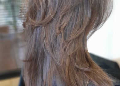 Elegant layered hairstyle at Lelani Hair in Broome, Western Australia, AU, showcasing a chic brown cut.
