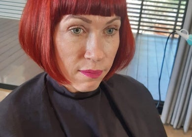 Modern red bob hairstyle at Lelani Hair, Broome, Western Australia, AU. Expert styling in a chic salon setting.