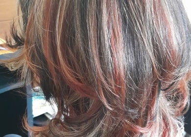 Stylish hair highlights at Lelani Hair in Broome, Western Australia, AU, showcasing vibrant color blending.