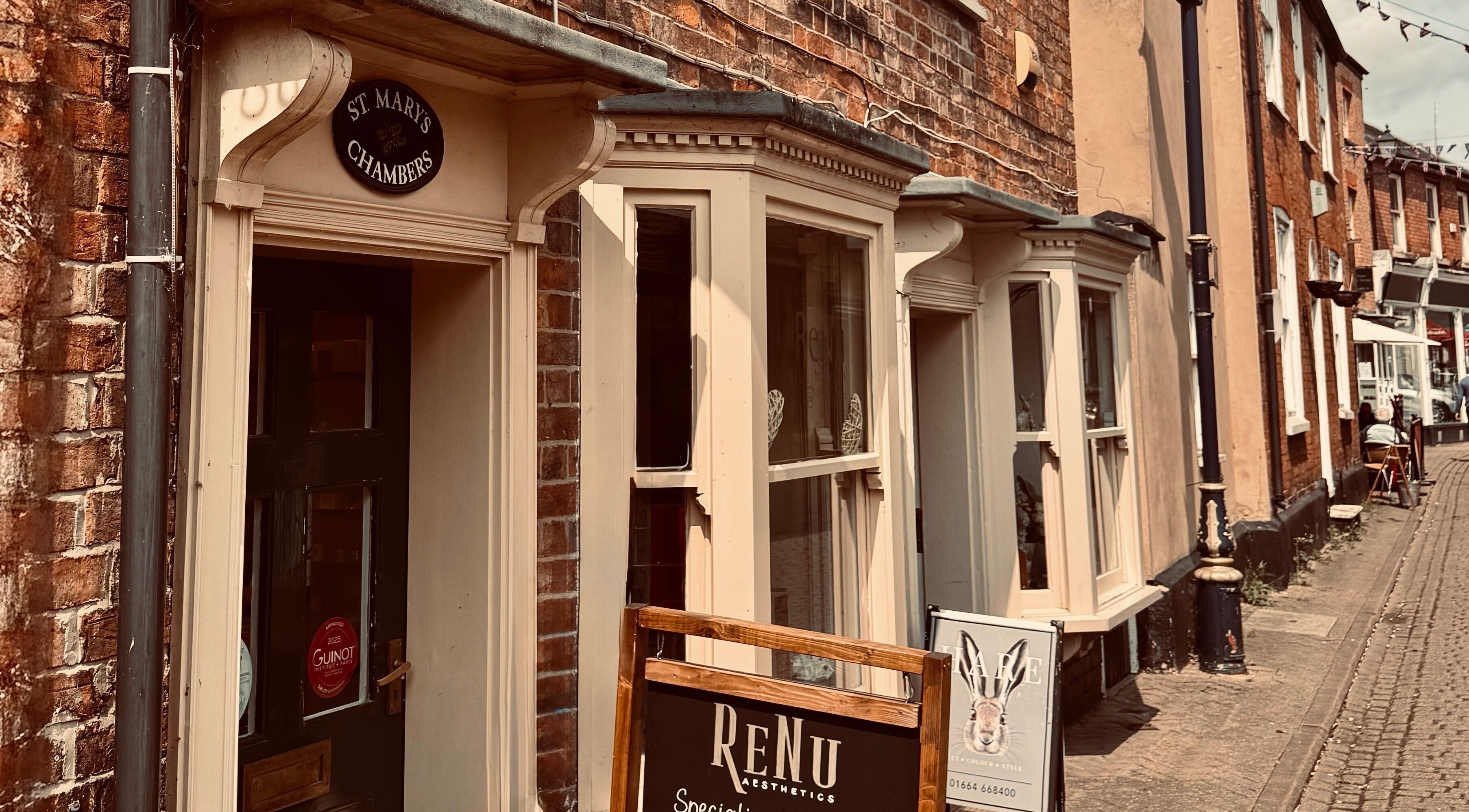 Exterior view of Renu Beauty on a quaint street in Melton Mowbray, England, GB, showcasing its welcoming brick facade.