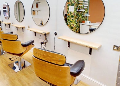 Modern salon chairs at Auburn Hair & Beauty, Barnham, England, GB, showcasing elegance and comfort.