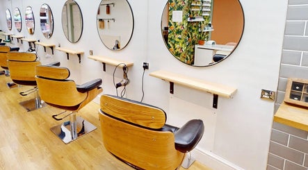Modern salon chairs at Auburn Hair & Beauty, Barnham, England, GB, showcasing elegance and comfort.