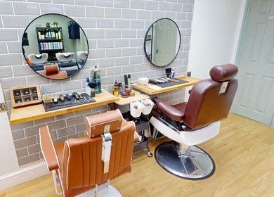 Modern barber chairs in Auburn Hair & Beauty, Barnham, England, GB, showcasing sleek salon design.