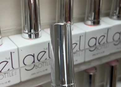 Auburn Hair & Beauty in Barnham, England, displays sleek gel polish bottles on a shelf.