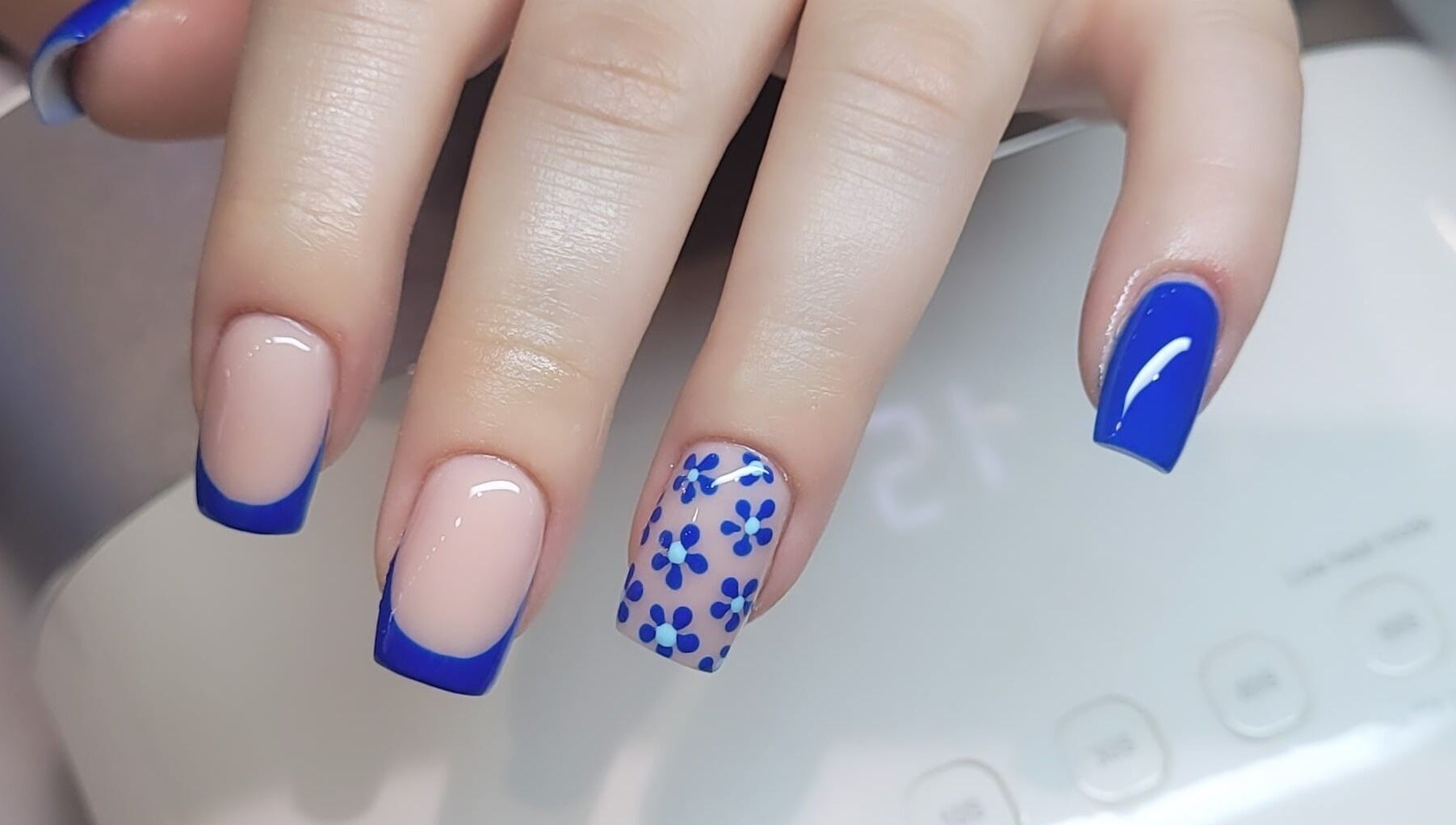 Elegant floral blue nail art at Tina Jane, Urmston, England, GB. Perfect for a chic style.