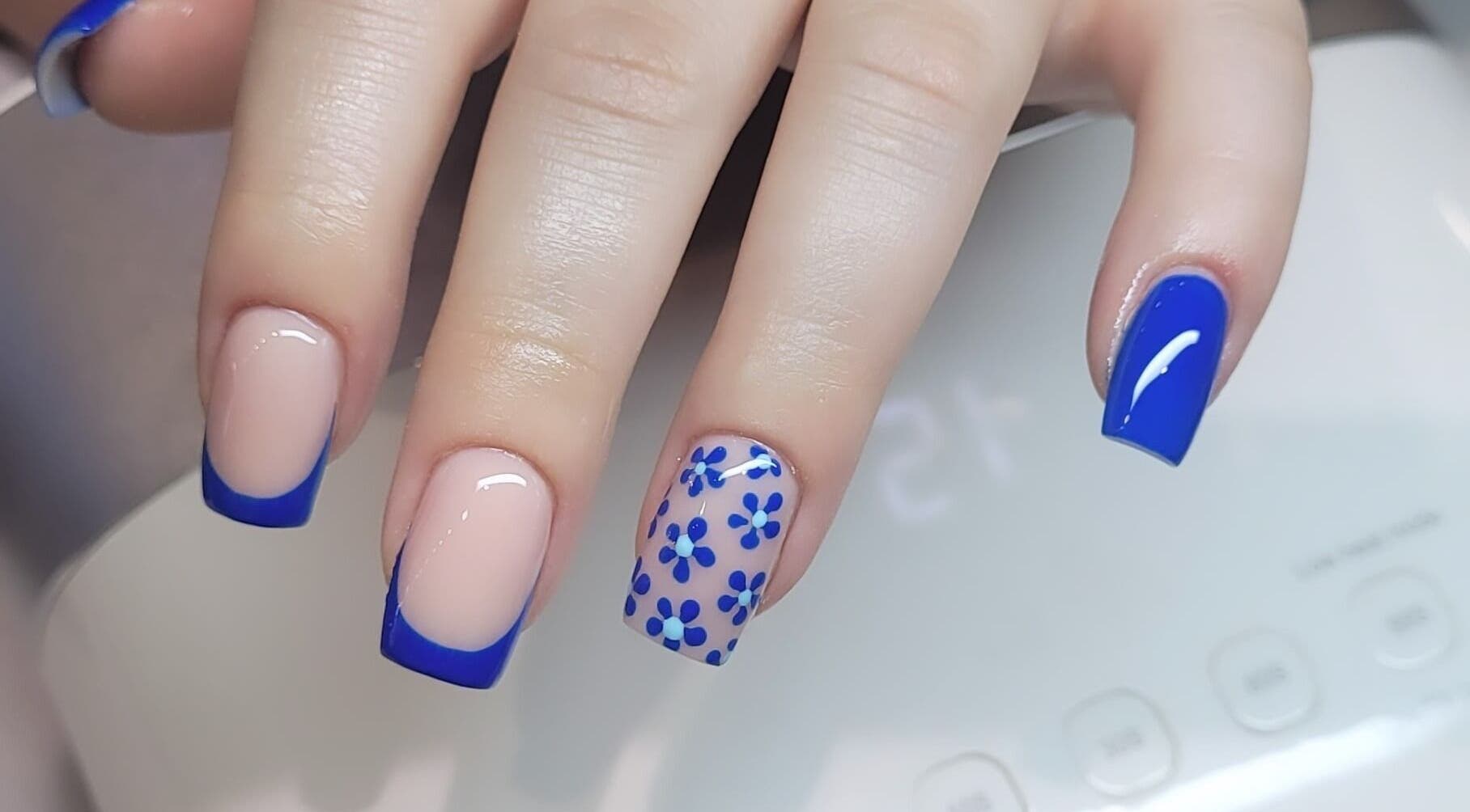 Elegant floral blue nail art at Tina Jane, Urmston, England, GB. Perfect for a chic style.