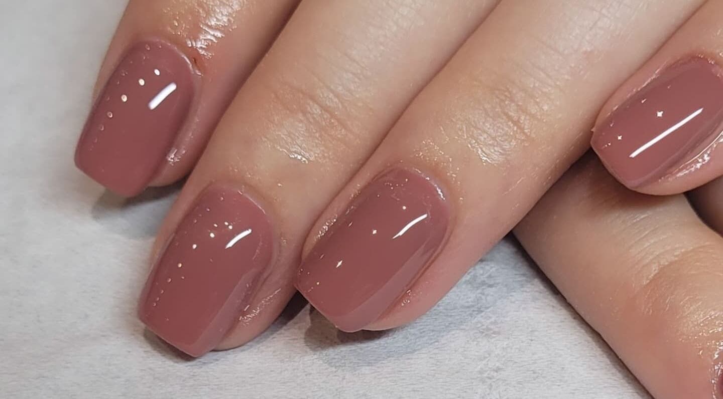 Elegant mauve manicure at Tina Jane in Urmston, England, GB, showcasing glossy nails.