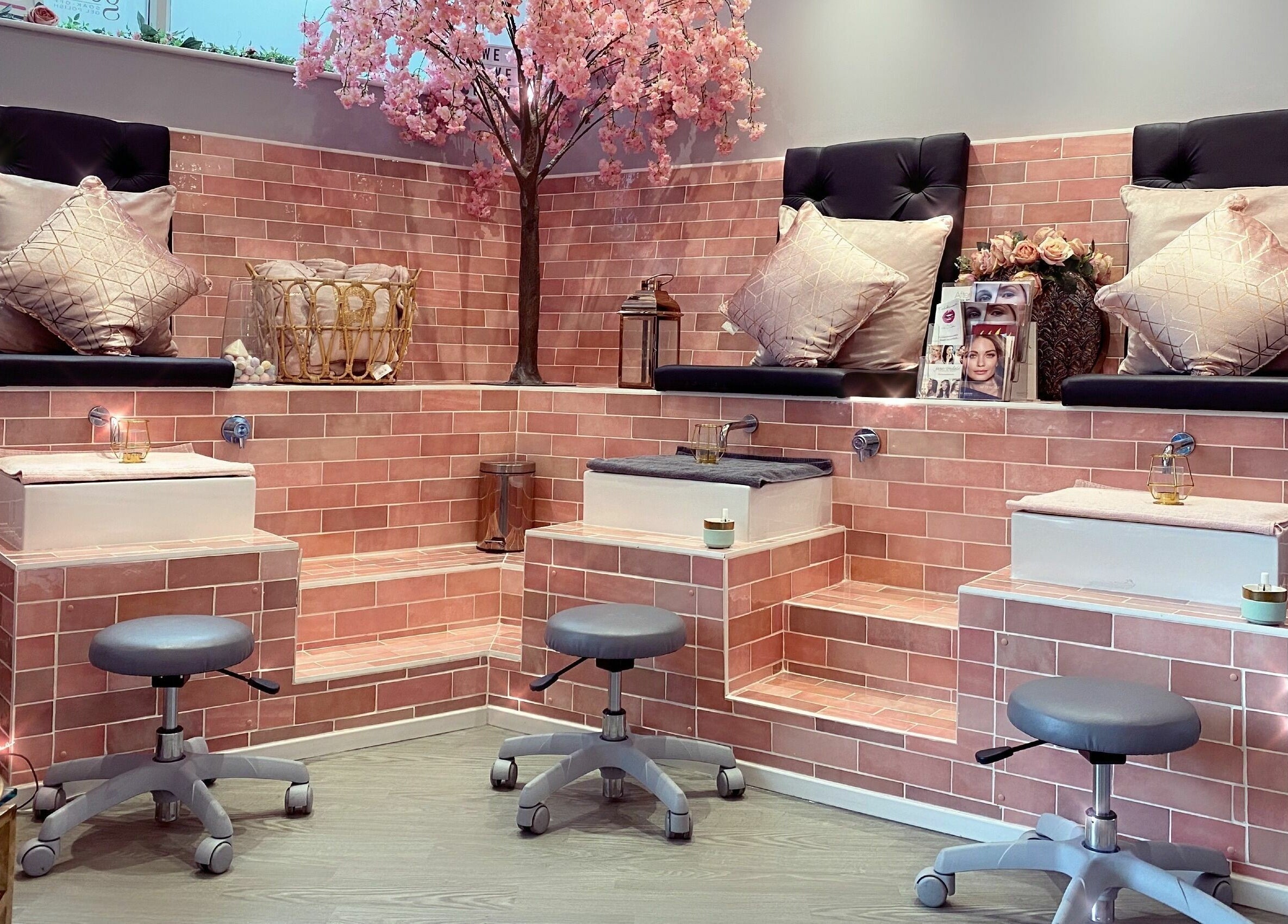 Luxurious seating area at Polished, Torquay, England. Elegant pink decor and relaxing ambiance.