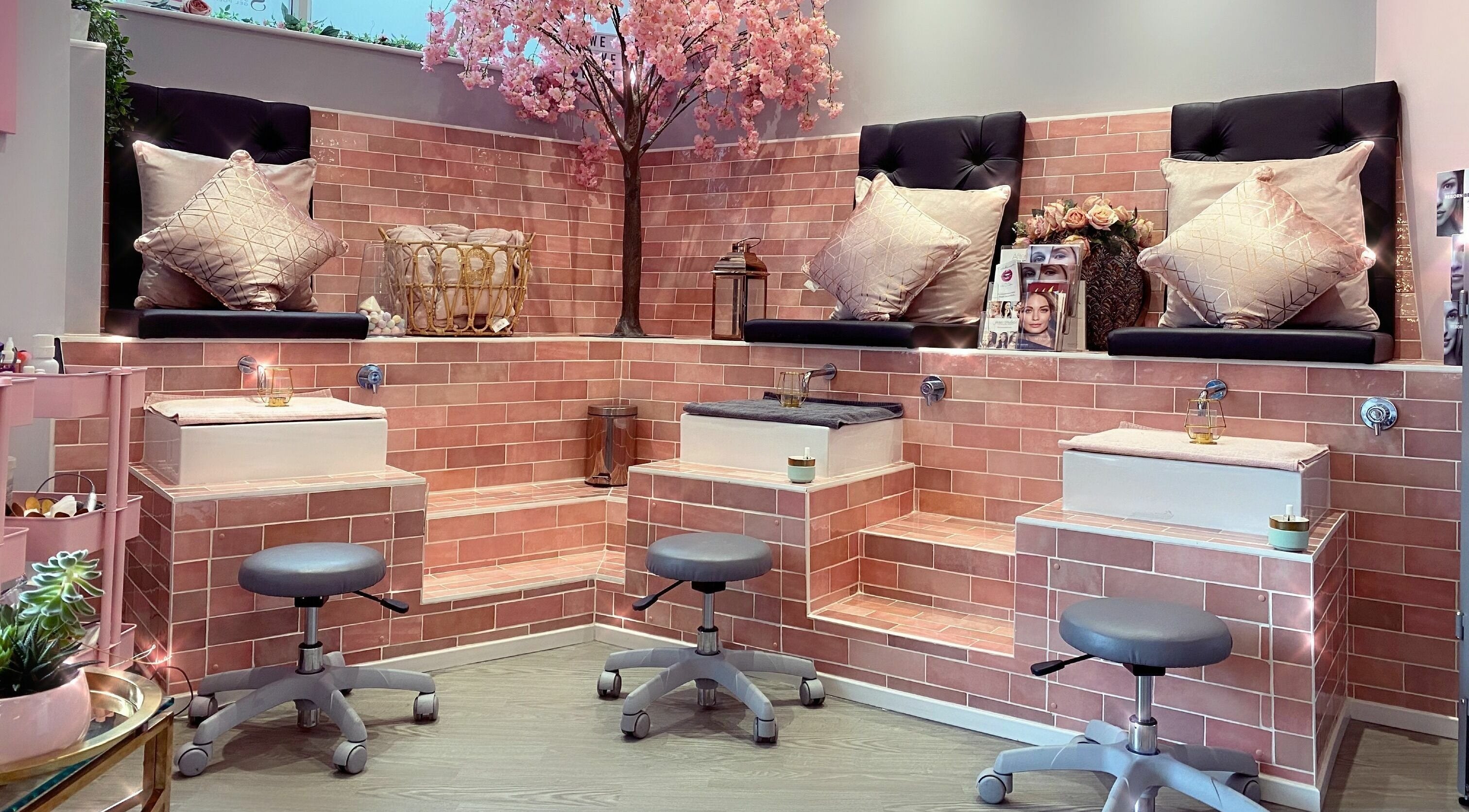 Luxurious seating area at Polished, Torquay, England. Elegant pink decor and relaxing ambiance.