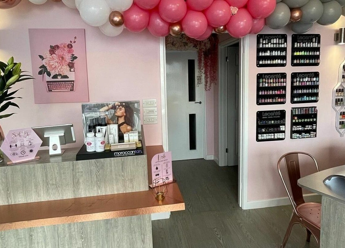 Stylish entrance at Polished, a beauty salon in Torquay, England, GB with vibrant decor and products on display.