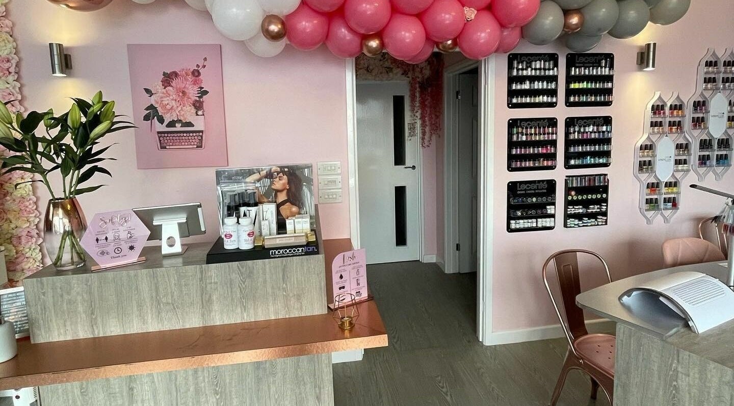 Stylish entrance at Polished, a beauty salon in Torquay, England, GB with vibrant decor and products on display.