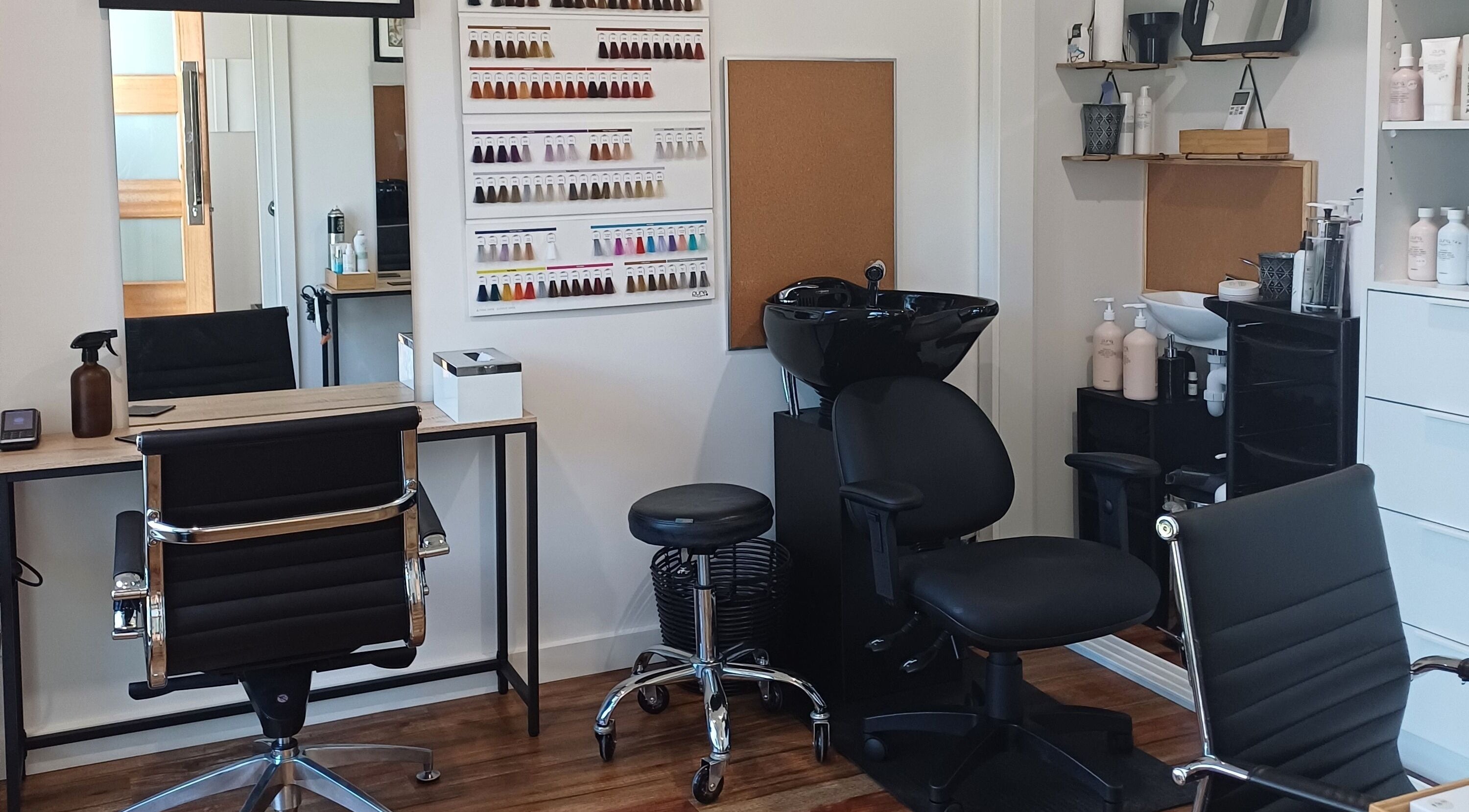 Modern salon interior at Master Kuts, Bendigo, Victoria, AU, featuring stylish chairs and hair styling tools.