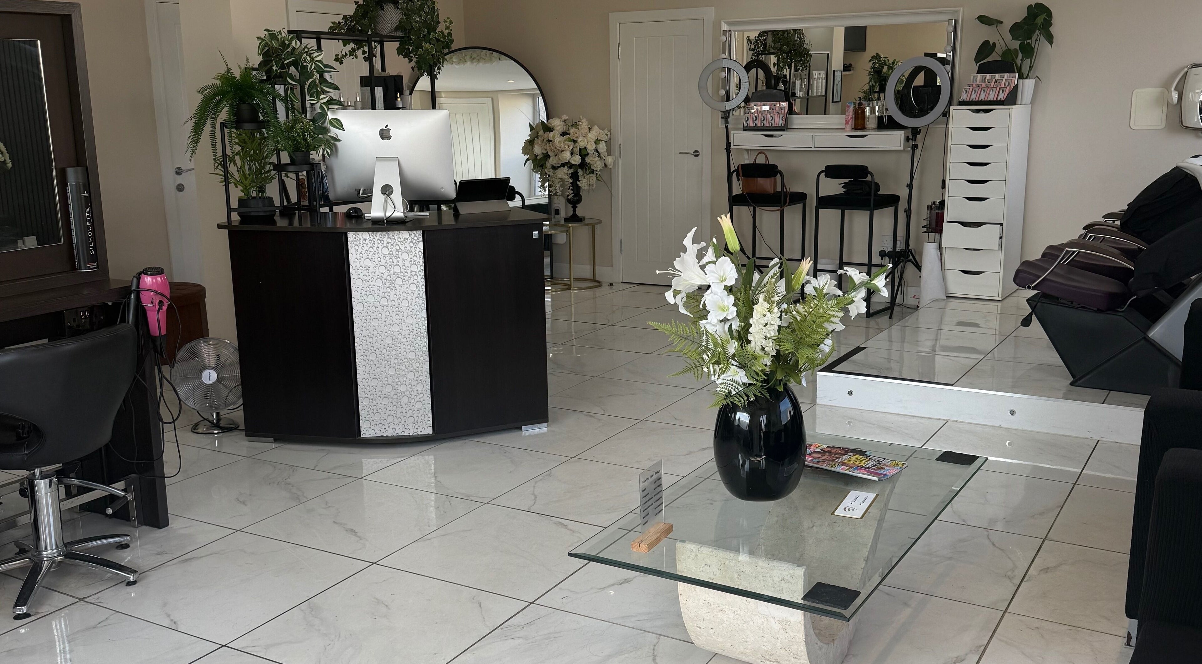 Elegant interior of Flawless Hair And Beauty, Kelty, Scotland, GB, featuring chic decor and modern styling stations.